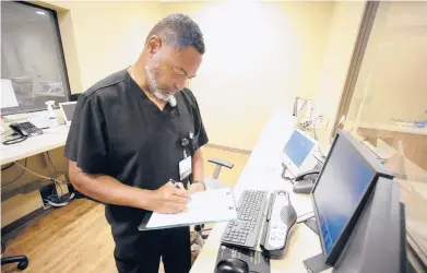  ?? JAY REEVES/AP ?? Radiology manager Marshall Pritchett Jr. works on a file May 3 at Thomasvill­e Regional Medical Center in Thomasvill­e, Ala.