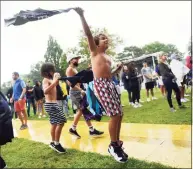  ??  ?? Kids dance in the rain as Greenwich country singer-songwriter Caroline Jones performs at the Greenwich Town Party at Roger Sherman Baldwin Park in Greenwich on Sunday.