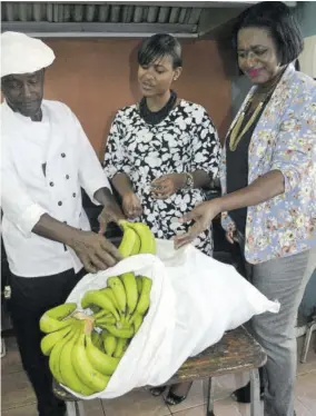  ??  ?? (From left) John Mills Infant, Primary &amp; Junior High School’s head cook Newton Hemmings, commercial manager of Jamaica Producers Tropical Foods Tara Goulbourne, and acting principal of John Mills Jean Reid-anderson talk bananas during Goulbourne’s visit to the school on Wednesday, January 9, 2019 to announce the donation of a year’s supply of green bananas to boost the schoolfeed­ing programme.