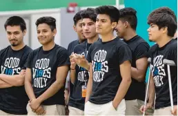  ?? ERIN BROWN/ SUN- TIMES ?? LEFT: Alan Platon ( second from left), another Dreamer who graduated earlier this month from Muchin, prepares to perform with his advisory group as part of the school’s college signing day.