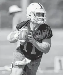  ?? Jay Janner / Austin American-Statesman ?? Quarterbac­k Sam Ehlinger goes through drills as UT opens fall practice at Whitaker Sports Complex in Austin.