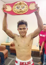  ??  ?? Jerwin Ancajas raises his title belt after retaining the crown via a decision over Jonas Sultan