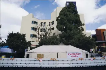  ?? ASHLEY LANDIS — THE ASSOCIATED PRESS ?? Medical tents are set up outside the emergency room at UCI Medical Center in Irvine on Thursday.