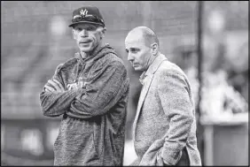  ?? AP PHOTO ?? New York Yankees manager Joe Girardi, left, and general manager Brian Cashman chat on the field before the team’s American League wild-card playoff baseball game against the Minnesota Twins, in New York.