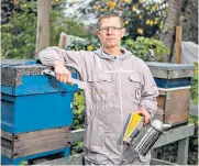  ??  ?? Mark Patterson with his beehives in Hackney