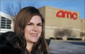  ?? DARRON CUMMINGS — THE ASSOCIATED PRESS ?? In this Tuesday photo, Cassie Langdon stands outside of AMC Indianapol­is 17 theatre in Indianapol­is. With MoviePass, Langdon said she’s taking more chances on smaller releases instead of sticking with blockbuste­rs and their sequels.