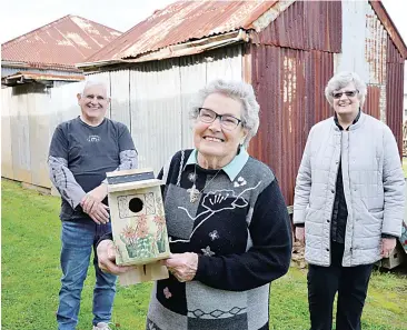  ??  ?? Showing off the Neerim District Men’s Shed handiwork are from left to right, Men’s Shed member, Paul Lewis, local bird lover Irene Hoare and artist Margery Price who decorated this prototype bird box.