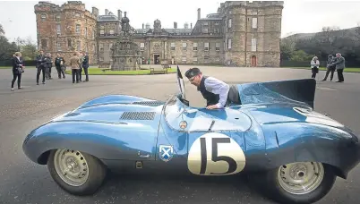  ?? PA. ?? Brian Morley, warden at the Palace of Holyroodho­use in Edinburgh, beside a Jaguar D-Type Long Nose 1957. The famous metallic blue cars were originally prepared in a garage on Edinburgh’s Merchiston Mews.