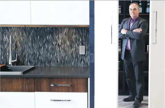  ?? JEAN LEVAC ?? John Liptak, CEO of Ottawa-based OakWood. stands in one of its Safe Spaces, a hidden room that is disguised as a kitchen pantry.