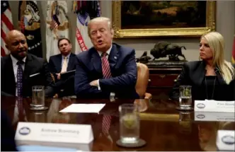  ?? LEAH MILLS / REUTERS ?? US President Donald Trump talks with local and state officials, including Indiana Attorney General Curtis Hill (left) and Florida Attorney General Pam Bondi (right), about improving school safety in a meeting at the White House in Washington on Thursday.