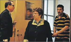  ?? ©DIANE CROCKER/THE WESTERN STAR ?? Legal aid lawyer Gary Kearney holds the door to courtroom at provincial court in Corner Brook open as his client Dorothy Brown and her son, Cory, enter.