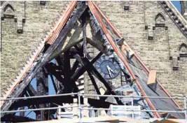  ?? MILWAUKEE JOURNAL SENTINEL CHRIS KOHLEY / ?? Charred beams can be seen at Trinity Evangelica­l Lutheran Church on Wednesday, the day after the church caught fire. The fire was large enough to damage the building's structural integrity.