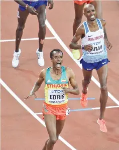  ??  ?? Ethiopia’s Muktar Edris (L) wins ahead of Britain’s Mo Farah (R) in second place in the final of the men’s 5000m athletics event at the 2017 IAAF World Championsh­ips at the London Stadium in London. - AFP photo