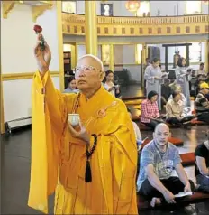  ??  ?? The Most Ven. Sakya Tri-Tue blesses the temple during the dedication.