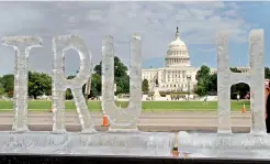  ?? — AFP ?? An ice sculpture is seen spelling out the word ‘truth’ by artist Duo Ligorano Reese, with the Capitol in the background, in Washington, DC, on Sunday.