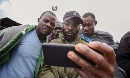  ?? Photograph: B Muthoni/Sopa/Shuttersto­ck ?? Kenyans follow the election news in Nairobi in 2022, when TikTok’s ‘For you’ algorithm fed inflammato­ry propaganda videos to millions of voters.
