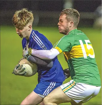  ??  ?? Mark Lundy of Tourlestra­ne in action with a Melvin Gaels defender last Friday at Ballyhauni­s. Pic: Tom Callanan.