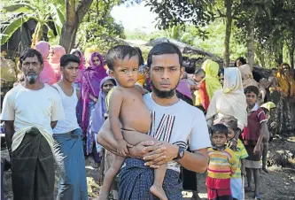  ?? Picture: AFP ?? MANAGED TO LEAVE: Mohammad Ayaz and his son, Mohammad Osman, who are the two survivors of his family, at a refugee camp at Ukhiya in southern Cox’s Bazar district yesterday