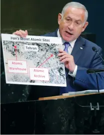  ?? (Caitlin Ochs/Reuters) ?? PRIME MINISTER Benjamin Netanyahu reveals images of an atomic warehouse in Tehran at the 73rd United Nations General Assembly on Thursday.