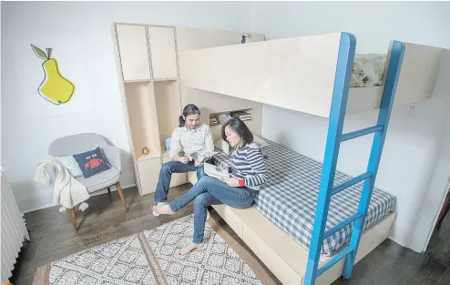  ?? PETER J. THOMPSON / NATIONAL POST ?? Rock Huynh and My Le Nguyen, the husband-and-wife team behind 1925 Workbench, put the finishing touches on a Baltic birch bunk bed for their two sons last week. The bunk features shelving and a minimalist flourish.