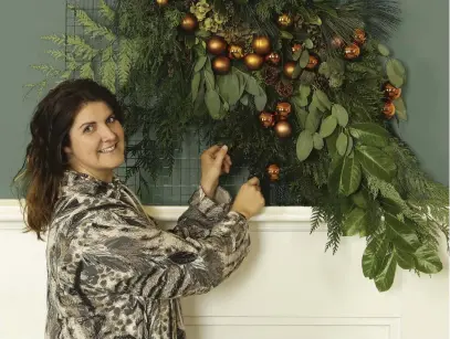  ?? Photos: Dobbies Garden Centres/PA ?? Dobbies stylist Rebecca Stanton with the finished festive floral tapestry.