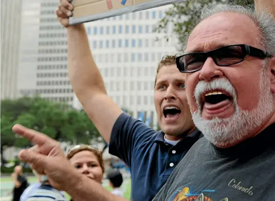 ?? AP ?? Ray Hill, right, and a counter-protester try to shout each down during an Occupy Wall Street rally in Houston, Texas, in 2011.
