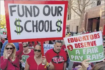  ?? Damian Dovarganes / Associated Press ?? Thousands of teachers marched in this December downtown Los Angeles rally. Even when a contract is agreed on, the school district must deal with deficit spending due to pensions.