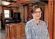  ??  ?? Rhonda Hefton poses for a photo in a vacant house that HopeHouse OKC plans to renovate for a partnershi­p project with ReMerge.