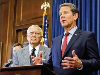  ?? BOB ANDRES / BANDRES@AJC.COM ?? Republican candidate Brian Kemp (right) and Gov. Nathan Deal hold a news conference Thursday at the Capitol. “We won the race, and we’re moving forward,” Kemp said.