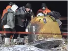  ?? REN JUNCHUAN/XINHUA NEWS AGENCY VIA AP ?? Crew members check the capsule of the Chang’e 5 probe Dec. 17, 2020, in north China’s Inner Mongolia Autonomous Region.