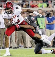  ?? Arkansas Democrat-Gazette/BENJAMIN KRAIN ?? Arkansas State’s Blake Mack is tackled by SMU safety Rodney Clemons during the first half of Saturday night’s game in Dallas. ASU led 14-10 after one quarter, but SMU took over after that.