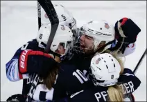  ?? ASSOCIATED PRESS ?? GIGI MARVIN (19), OF THE UNITED STATES, celebrates with her teammates after scoring a goal against Finland during the first period of the semifinal round of the women’s hockey tournament at the 2018 Winter Olympics in Gangneung, South Korea, Monday.