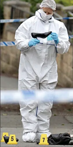  ??  ?? Tragic scene: A forensics officer examining Mrs Cox’s shoe