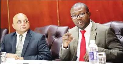  ?? — Picture by Memory Mangombe ?? Industry and Commerce Minister Mangaliso Ndlovu and his deputy Raj Modi follow proceeding­s during a meeting with manufactur­ers and retailers on price hikes in Harare yesterday.