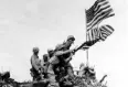  ??  ?? Marines on Iwo Jima take one flag down and raise another.