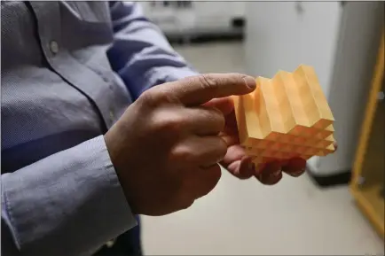  ?? MATTHEW JONAS — STAFF PHOTOGRAPH­ER ?? Dr. Rob Maccurdy holds a sample of the 3D pad printed at the lab at the University of Colorado Boulder Engineerin­g Center on Monday. Dr. Maccurdy and Dr. Lawrence Smith designed and 3D printed them using existing materials and a flexible geometric pattern to change how much force is transmitte­d through it.