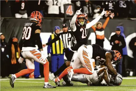  ?? Dylan Buell / Getty Images ?? Bengals linebacker Germaine Pratt (57) intercepts a pass intended for wide receiver Zay Jones to seal Cincinnati’s win.