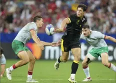  ?? Pavel Golovkin/Associated Press ?? Wales’ Louis Rees-Zammit, center, passes the ball during the Rugby World Cup Pool C match between Wales and Portugal in the Stade de Nice, in Nice, France, Sept. 16, 2023. Rees-Zammit is one of 16 athletes from eight countries participat­ing in the NFL Internatio­nal Player Pathway program.