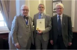  ?? ?? Vincent Schouberec­hts FRPSL (centre) receives a certificat­e and plaquette from Peter Cockburn FRPSL, President of the Royal Philatelic Society London (left). On the right is Reg Harrison who gave the Vote of Thanks