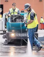  ??  ?? City worker Chris Coche uses a power washer to clean an alley in Downtown Albuquerqu­e on Wednesday morning.