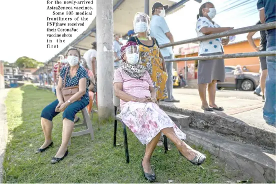  ?? LUIS ACOSTA/AGENCE FRANCE-PRESSE ?? PEOPLE wait to be inoculated with the Pfizer-BioNTech vaccine amid the novel coronaviru­s pandemic, at the Carlos A Mendoza school in San Miguelito, Panama City.