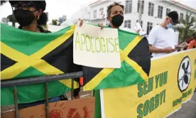  ?? Photograph: Ricardo Makyn/AFP/Getty Images ?? People calling for slavery reparation­s protest outside the entrance of the British high commission during the royal visit.