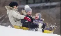  ?? SCOTT EISEN, GETTY IMAGES ?? A woman and her grandchild­ren sled in Boston following a winter storm Monday. The storm moved into parts of Maine Tuesday.