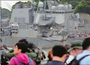  ?? EUGENE HOSHIKO/AP PHOTO ?? Journalist­s observe the damaged USS Fitzgerald at the U.S. Naval base in Yokosuka, Japan, earlier this month.