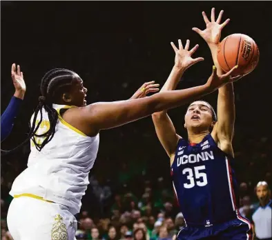  ?? Michael Caterina / Associated Press ?? Notre Dame’s Lauren Ebo (33) drives as UConn’s Azzi Fudd defends during the first half on Sunday.