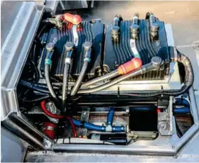  ??  ?? ABOVE A bank of lithium-ion batteries provide the electrical power to a pair of high-output digital AC induction motors driving the boat via a convention­al Mercruiser sternleg with direct drive.