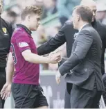  ??  ?? 2 James Forrest shakes hands with Brendan Rodgers in the defeat by Hibs. Celtic’s next chance to win the league is against Rangers on Sunday.