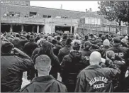  ?? RICK WOOD/MILWAUKEE JOURNAL-SENTINEL ?? Hundreds of police officers pay their respects as Officer Matthew Rittner’s casket is loaded into a hearse Wednesday outside the Medical Examiner’s office in Milwaukee.