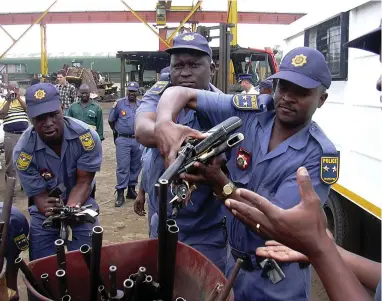  ??  ?? GUNNING FOR CHANGE: Police destroyed 722 guns, which were crushed into scrap metal at a recycling plant in Prospecton during the third such destructio­n event, a final step in the process of Operation Sethunya.