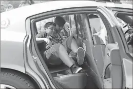  ?? Spencer Lahr / Rome News-Tribune ?? Alto Park Elementary students Josue Barrious (left), 9, and David Santillan, 10, climb through the back of a Floyd County police car Friday in the school parking lot during Career Day.